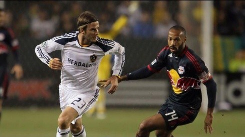 David Beckham playing for the Los Angeles Galaxy and Thierry Henry with the New York Red Bulls.