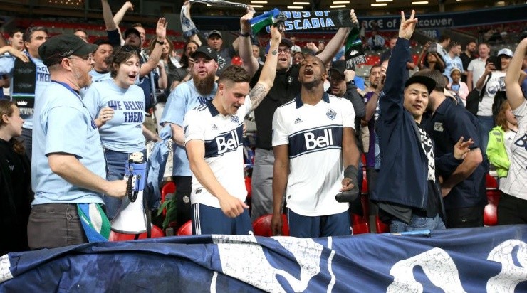 Vancouver Whitecaps defender Jake Nerwinski (28) and teammate defender Doneil Henry (2) celebrate with fans after winning their match against the Portland Timbers. (Getty)