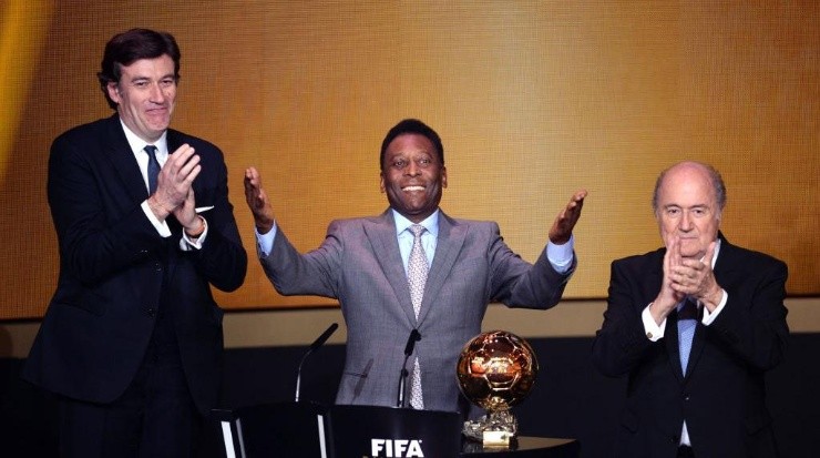 Pele celebrates after receiving the FIFA Ballon d'Or Prix d'Honneur award next to France Football president Francois Moriniere (L) and FIFA president Sepp Blatter during the FIFA Ballon d'Or Gala 2013 