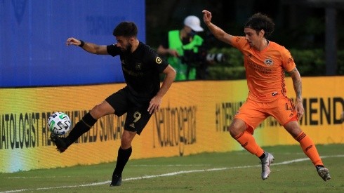 Diego Rossi of Los Angeles FC (left) fights for the ball with Zarek Valentin of Houston Dynamo (Getty).