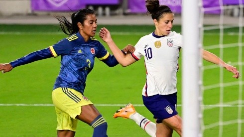 Carli Lloyd (right) of the United States shoots the ball against Sandra Sepulveda (left) of Colombia. (Getty)