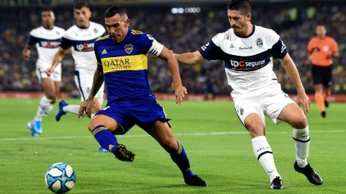 Carlos Tevez of Boca Juniors (left) drives the ball against Maximiliano Coronel of Gimnasia (Getty).