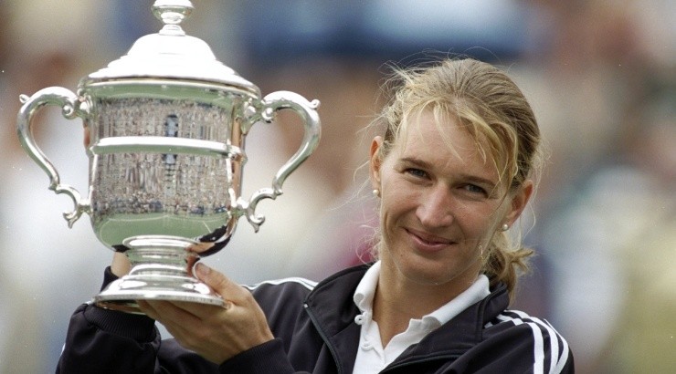 Steffi Graf of Germany holds the trophy aloft after winning at the 1995 US Open. (Getty)