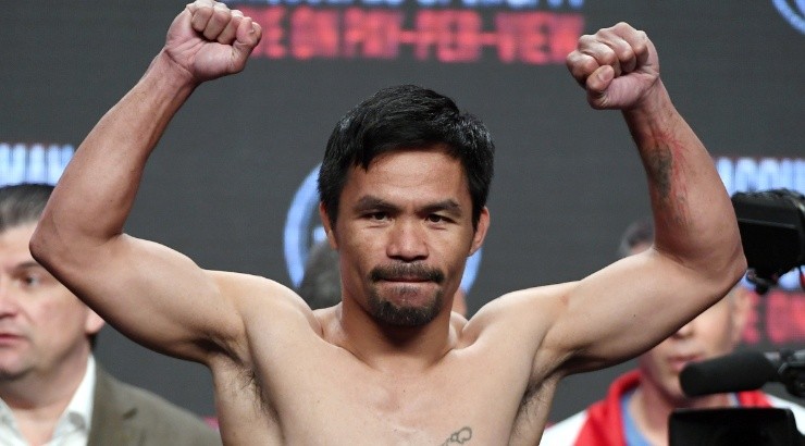 WBA welterweight champion Manny Pacquiao poses on the scale during his official weigh-in. (Getty)
