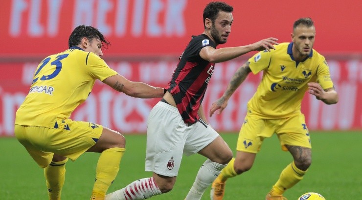 Hakan Calhanoglu (centre) of Milan is challenged by Giangiacomo Magnani (left) of Hellas Verona. (Getty)