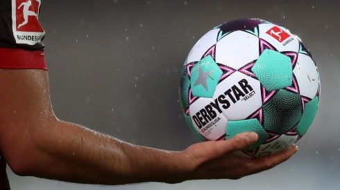 Bayer Leverkusen player holds the official Derbystar match ball during the 2020-21 Bundesliga. (Getty).jpg