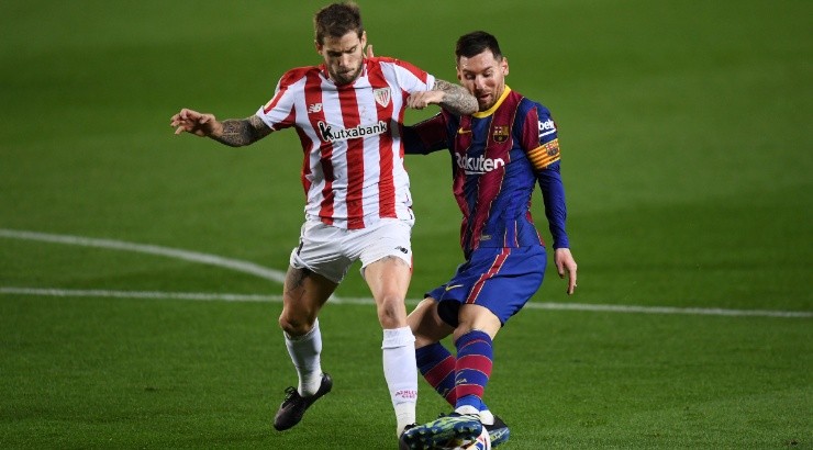 Lionel Messi (right) of Barcelona battles for possession with Inigo Martinez (left) of Athletic Bilbao. (Getty)