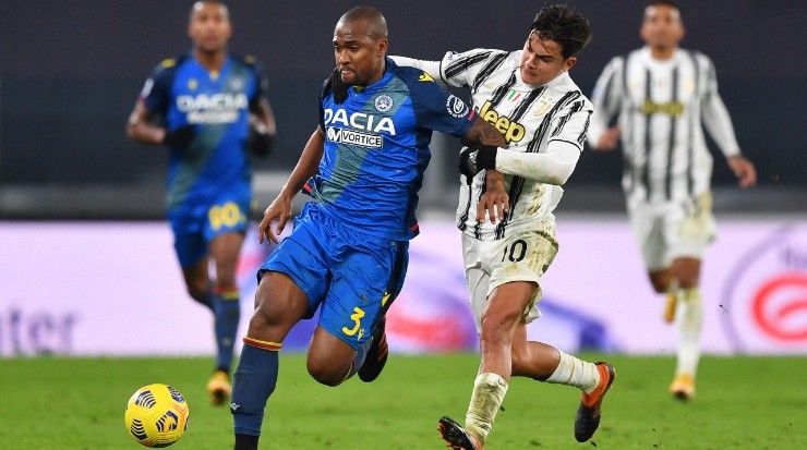 Samir of Udinese (left) is pulled back by Paulo Dybala of Juventus (right). (Getty)