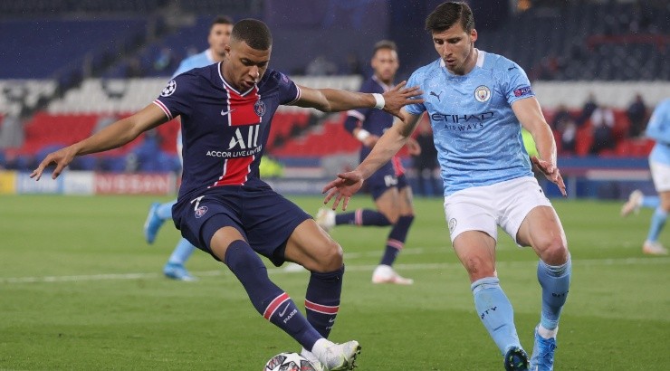 Kylian Mbappe of Paris Saint-Germain (left) is challenged by Ruben Dias of Manchester City (right). (Getty)