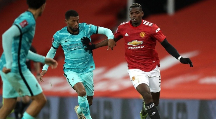 Paul Pogba of Manchester United (right) is challenged by Georginio Wijnaldum of Liverpool (left). (Getty)