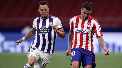 Vitolo of Atletico Madrid (riight) battles for possession with Oscar Plano of Real Valladolid (left). (Getty)