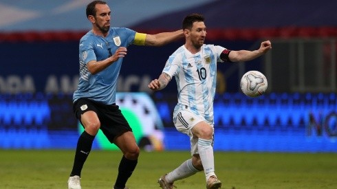 Lionel Messi of Argentina and Diego Godin of Uruguay compete for the ball (Getty).
