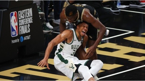 Clint Capela helps an injured Giannis Antetokounmpo. (Getty)