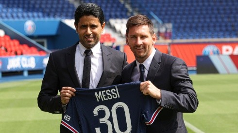 ionel Messi poses with his jersey next to PSG's President Nasser Al Khelaifi (Getty).