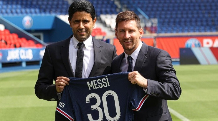 Lionel Messi poses with his jersey next to President Nasser Al Khelaifi after the press conference of Paris Saint-Germain at Parc des Princes on August 11, 2021 in Paris, France. (Getty)