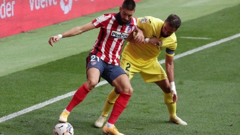 Yannick Carrasco of Atletico Madrid (left) holds the ball while Mario Gaspar of Villarreal (right) tries to block him (Getty)