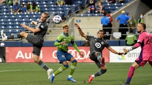 Brent Kallman #14 of Minnesota United FC heads a shot towards the goal as Stefan Frei #24 of Seattle Sounders FC defends during the second half of the match at Lumen Field on April 16, 2021 in Seattle, Washington. Seattle won 4-0. (Getty)