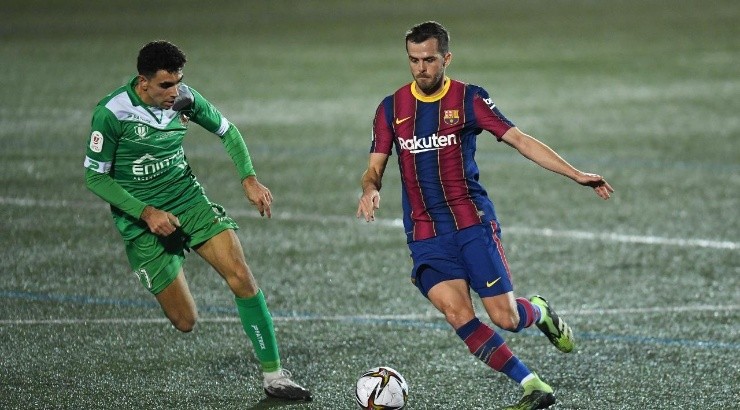 Miralem Pjanic of Barcelona is challenged by Javier Ontiveros Robles of Cornella during the Copa del Rey match between Cornella and FC Barcelona (Getty)