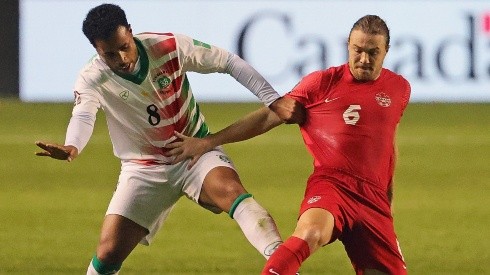 Roland Alberg of Suriname (left) battles with Samuel Piette of Canada (right)