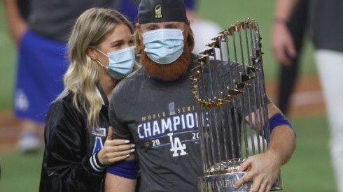Kourtney Pogue and Justin Turner of the Dodger (right) holding the Commissioner's Trophy after winning MLB championship.