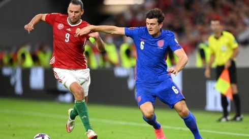 Adam Szalai of Hungary (left) fights for ball control against Harry Maguire of England