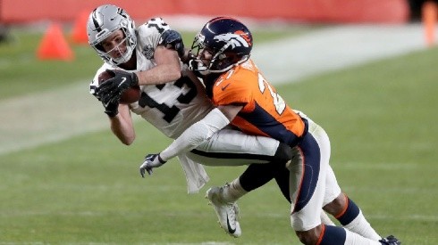 Hunter Renfrow of the Raiders (left) tries to gain more yards against Will Parks of the Broncos by Matthew Stockman