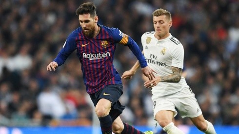 Lionel Messi and Toni Kroos in action during a Barcelona v Real Madrid El Clasico derby in 2019.
