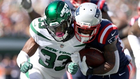 Adrian Colbert of the New York Jets (left) tries to stop James White of the New England Patriots