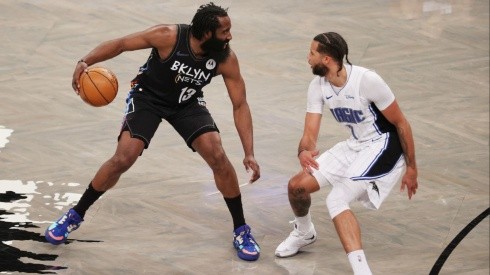 James Harden of the Nets (left) tries to pass drible Michael Carter-Williams of the Magic