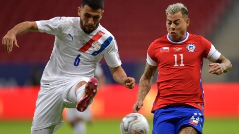 Junior Alonso of Paraguay fights for the ball with Eduardo Vargas of Chile.