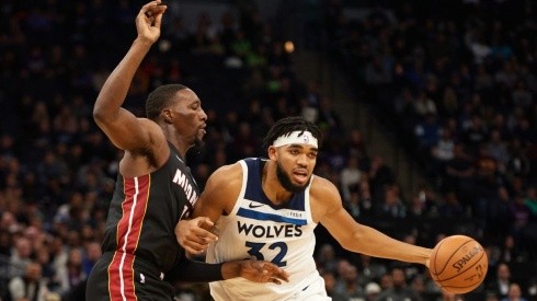 Bam Adebayo of Miami Heat (left) tries to block a shot from Karl-Anthony Towns of Minnesota Timberwolves