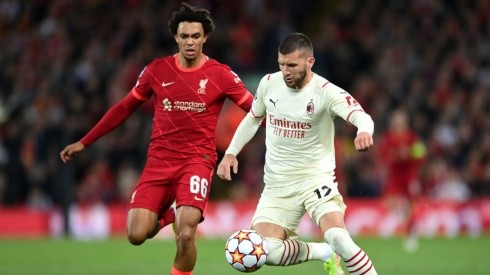 Trent Alexander-Arnold of Liverpool (left) tries to stop Ante Rebic of AC Milan
