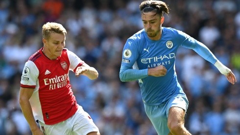Jack Grealish of Manchester City breaks away from Martin Odegaard of Arsenal.