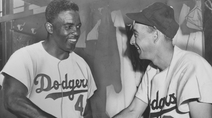 Jackie Robinson, greets a teammate. (Afro American Newspapers/Gado/Getty Images)