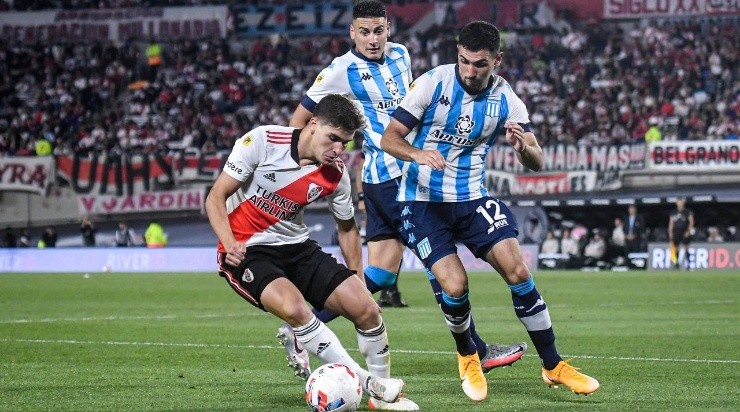 Julian Alvarez of River Plate drives the ball against Fernando Prado of Racing (Photo by Marcelo Endelli/Getty Images)