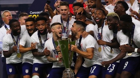 Paul Arriola #7 of United States and Sebastian Lletget #17 lifts the trophy to celebrate with his teammates after winning the CONCACAF Gold Cup 2021