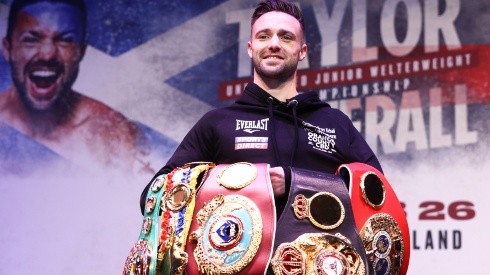 Josh Taylor stands with his titles
