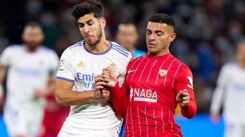 Marco Asensio of Real Madrid and  Diego Carlos of Sevilla