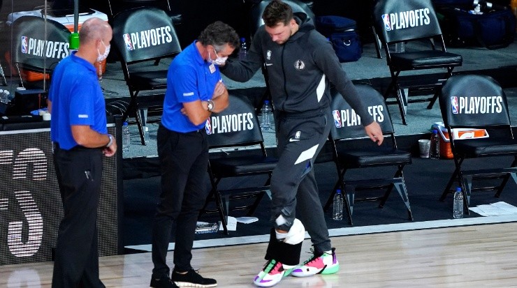 Luka Doncic suffering one of his multiple ankle injuries. (Ashley Landis-Pool/Getty Images)