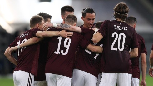 Latvia players celebrate after scoring