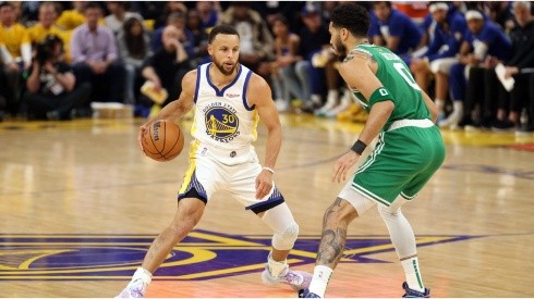 Stephen Curry of the Golden State Warriors dribbles against Jayson Tatum of the Boston Celtics