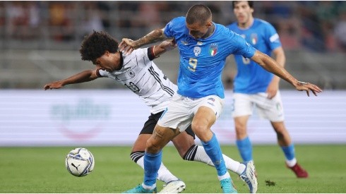 Serge Gnabry of Germany is challenged by Gianluca Scamacca of Italy