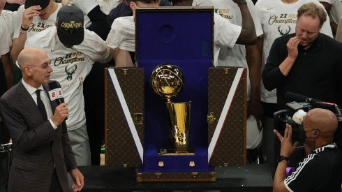 NBA commissioner Adam Silver presents the NBA title trophy at the 2021 NBA Finals