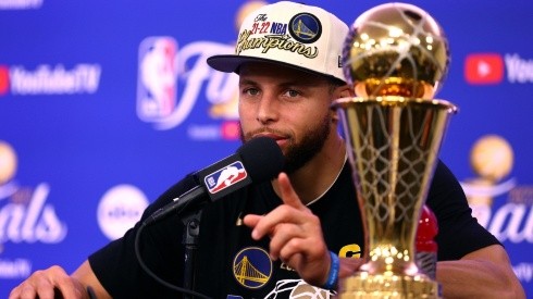 Curry with the NBA Championship trophy