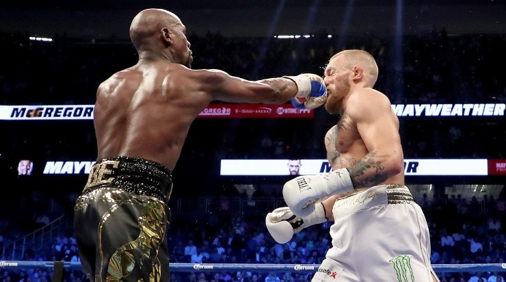 Floyd Mayweather Jr. throws a punch at Conor McGregor during their super welterweight boxing match on August 26, 2017 at T-Mobile Arena in Las Vegas, Nevada. (Photo by Christian Petersen/Getty Images)
