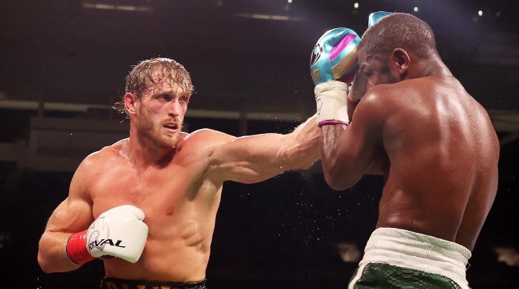 Floyd Mayweather exchanges blows with Logan Paul (yellow shorts) during their contracted exhibition boxing match at Hard Rock Stadium on June 06, 2021 in Miami Gardens, Florida. (Photo by Cliff Hawkins/Getty Images)