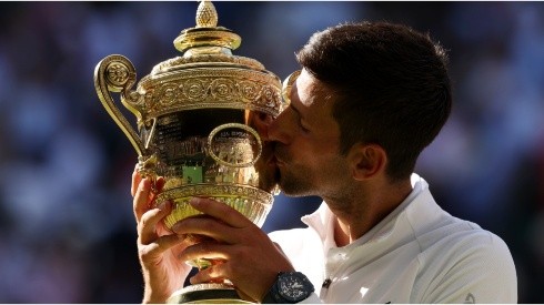 Novak Djokovic of Serbia kisses the Wimbledon trophy