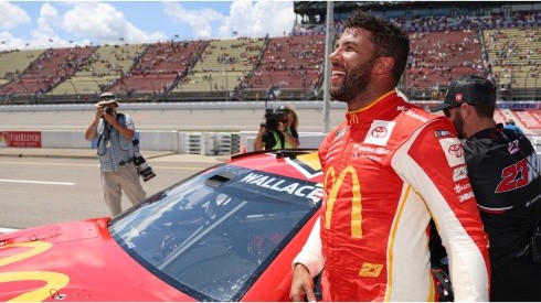 Bubba Wallace celebrates after winning the pole award for the FireKeepers Casino 400