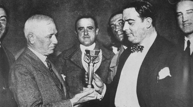 Jules Rimet, president of FIFA (Federation Internationale de Football), presents the first World Cup trophy (the Jules Rimet Trophy) to Dr Paul Jude, the president of the Uruguayan Football Association, (Photo by Keystone/Getty Images)