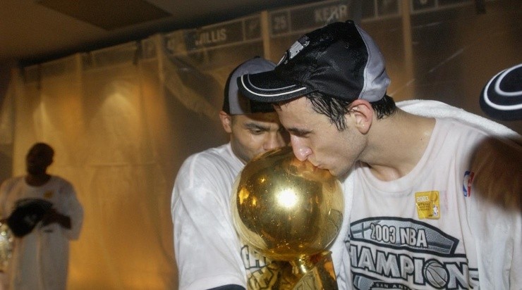 Emanuel Ginobili #20 and Tony Parker #9 of the San Antonio Spurs kiss the Championship trophy  (Photo by Ezra Shaw/Getty Images)